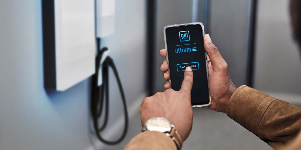 A person charging an powered EV using a smartphone.