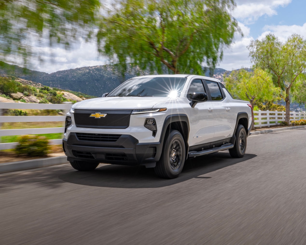 A GM Envolve vehicle driving on a mountainside road.