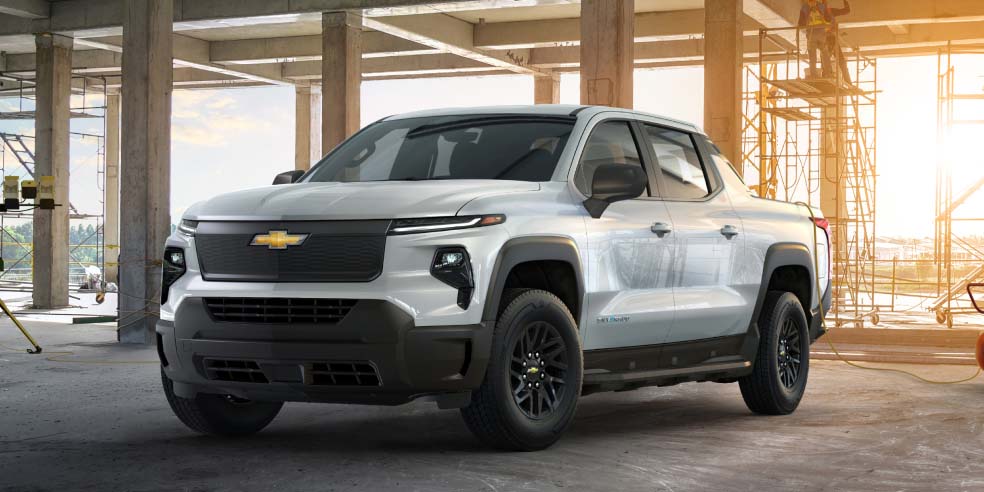 A Chevrolet Silverado EV parked alone under a construction area.