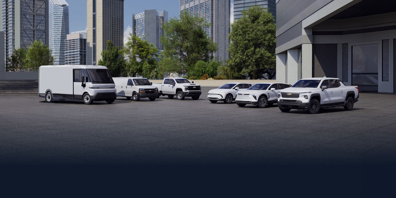 A lineup of GM Envolve vehicles parked outside a building.