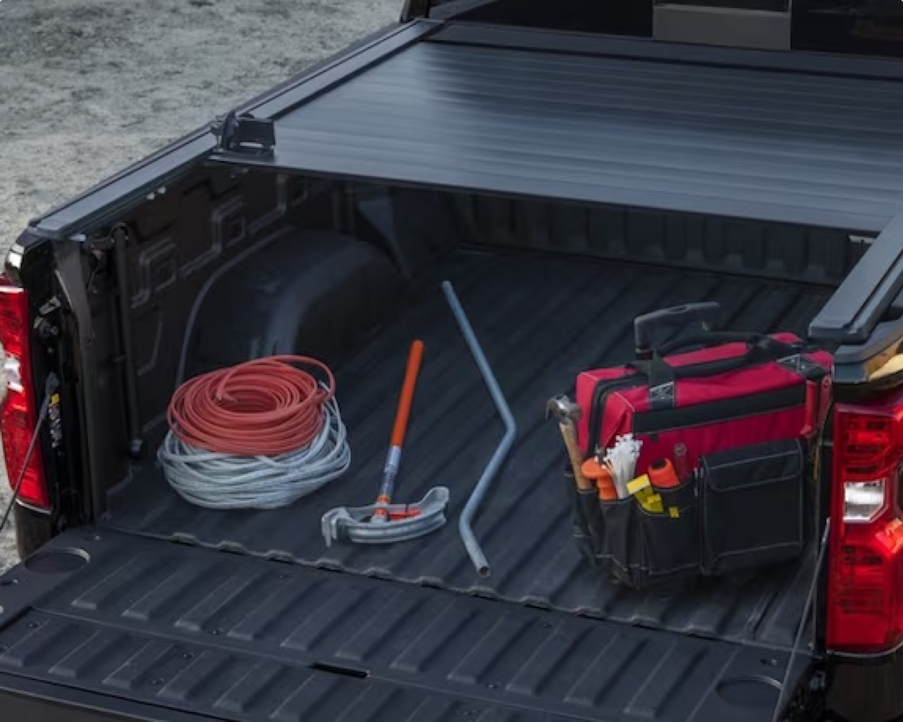 Close-up view of truck bed filled with various tools and equipment.