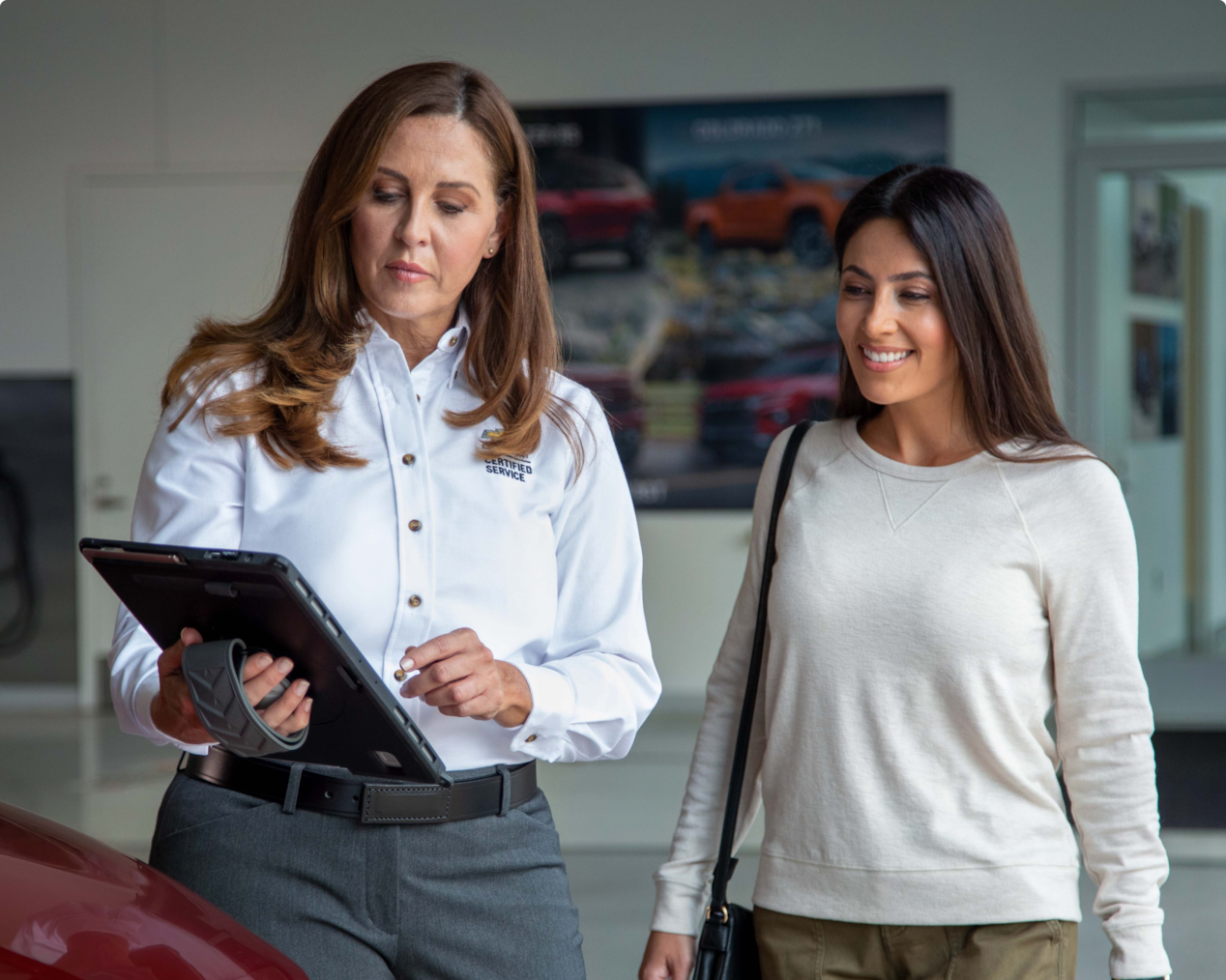 A GM vehicle owner having a discussion with a Certified Service Representative.