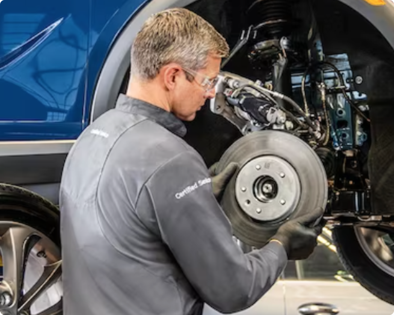 GM technician installing a brake rotor on a GM Fleet vehicle.