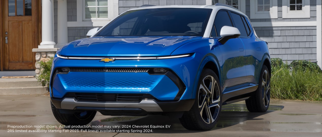 The 2024 Chevrolet Equinox EV parked in front of a house.