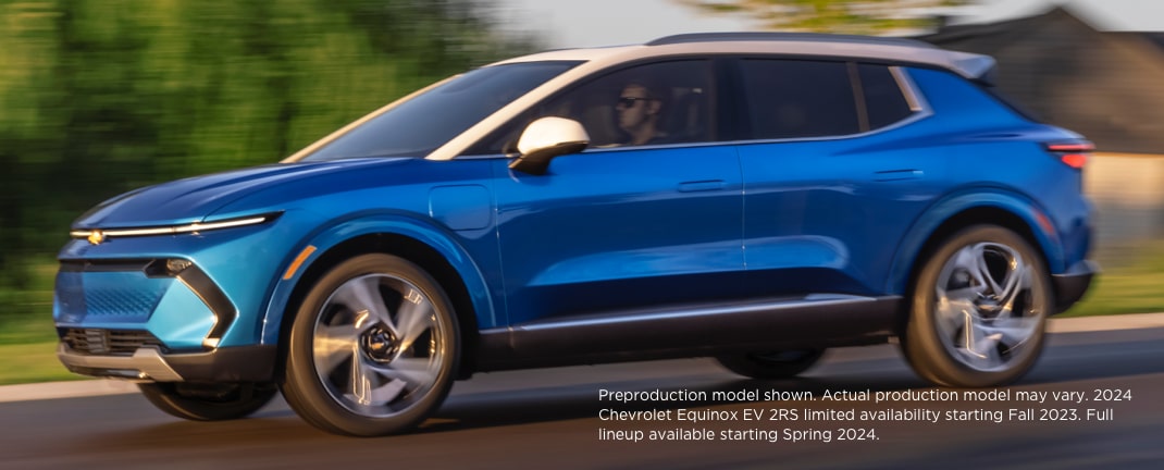 The New 2024 Equinox EV driving through a highway.