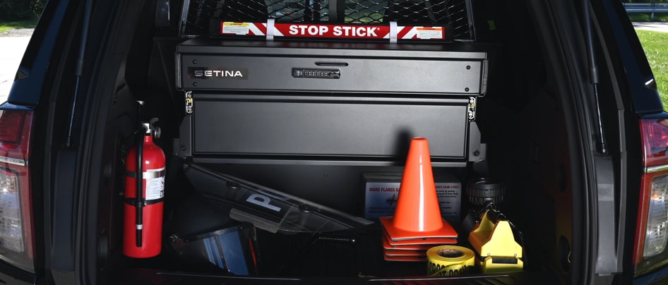 Trunk of Chevrolet police vehicle with gears inside.