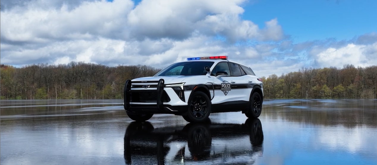 A GM Envolve Chevrolet Blazer EV Police Pursuit Vehicle driving by a city.