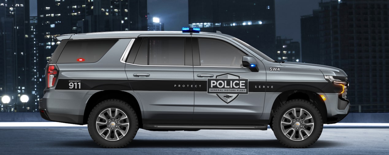 Side view of GM Envolve Chevrolet Tahoe PPV parked inside a steel bridge.