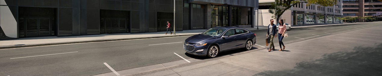 A GM Fleet vehicle parked alone in the city.