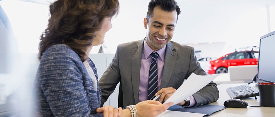 GM Financial personnel explaining commercial lending and finance options to a client.