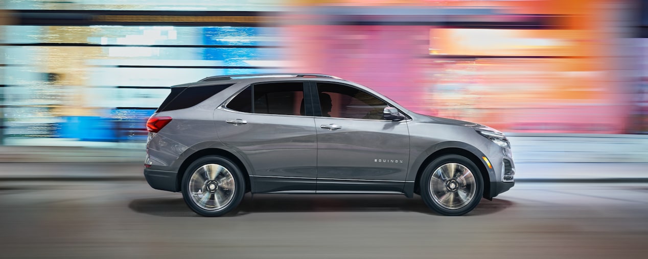 2024 Chevrolet Equinox driving fast in the city.