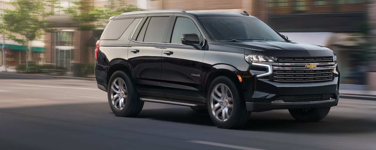 2024 Chevrolet Tahoe driving fast in the city.