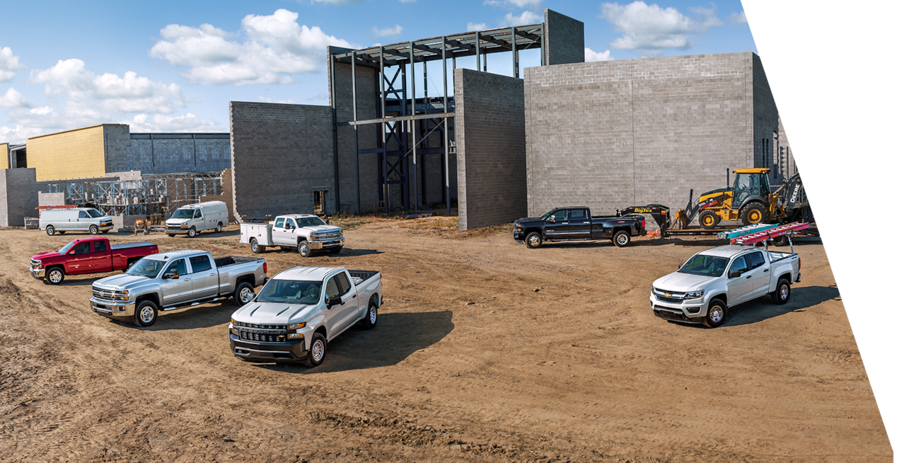 GM Envolve trucks parked beside each other near a construction site.