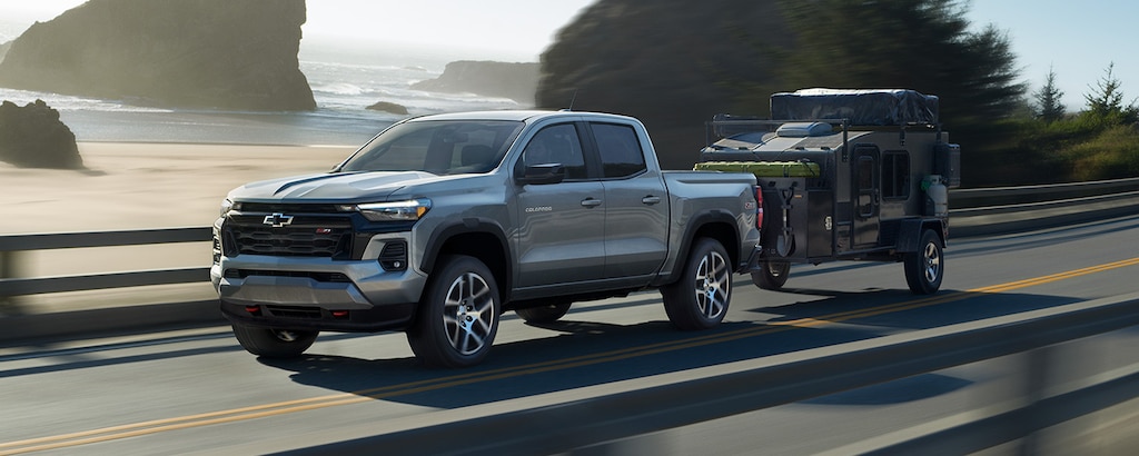 2024 GM Fleet Chevrolet Colorado driving on a road while trailering.