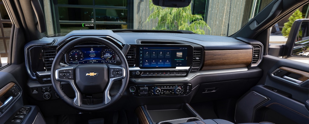 Driver's view of the digital dashboard, steering wheel and infotainment system on the 2024 Silverado HD.