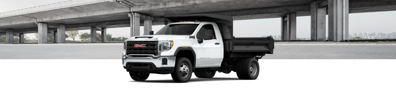 2024 GMC Sierra 3500 Chassis Cab Work Truck with a bridge in the backdrop.