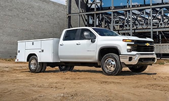 GM Envolve Utility/Service Upfit vehicle parked near a construction site.