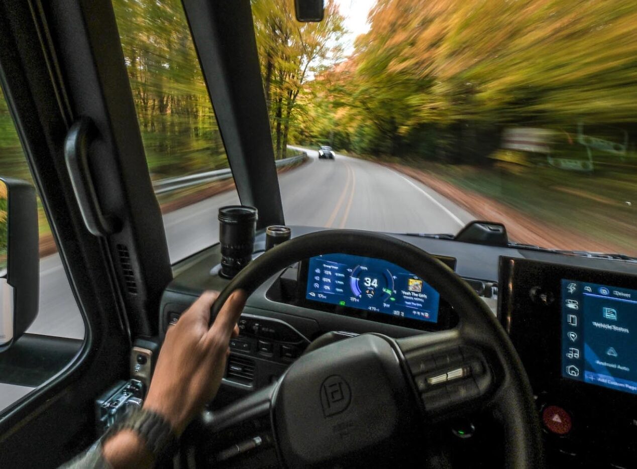 Interior of an OnStar-subscribed GM vehicle driving in a forest from the driver's point of view.