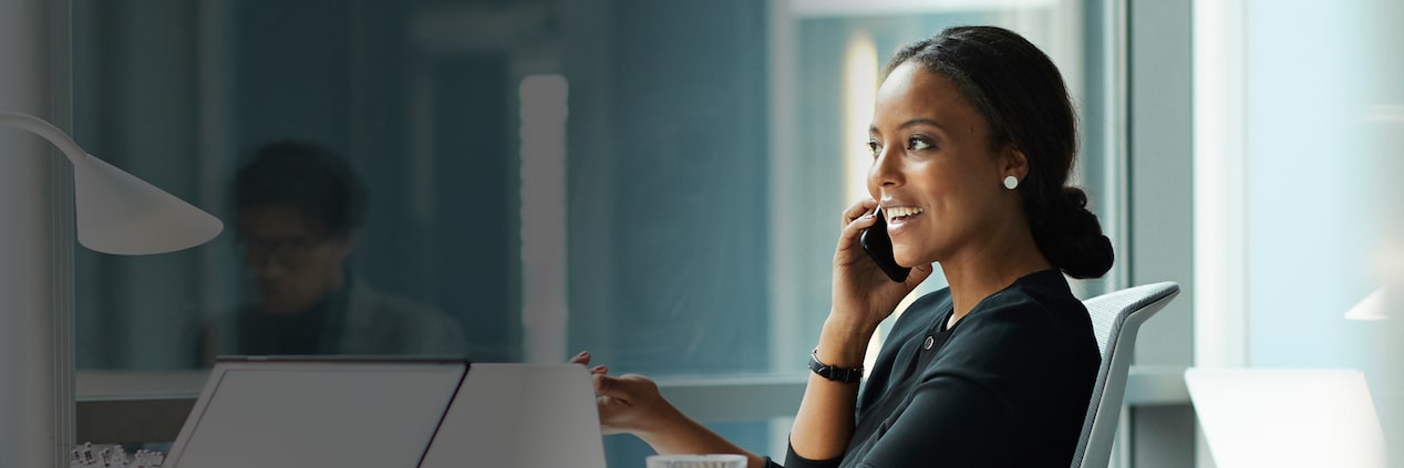 A woman speaking on the phone in her office