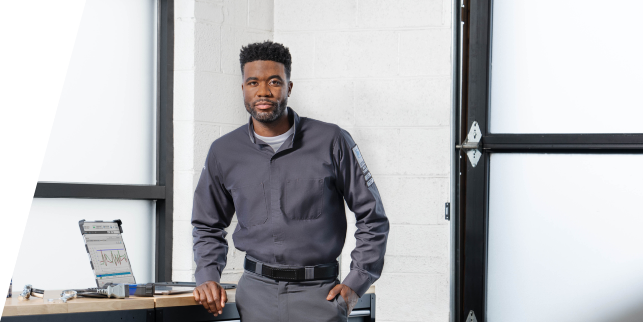 A GM Technician Standing Next to a Work Bench