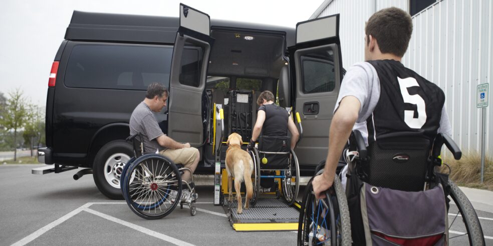 Three People in Wheelchairs Getting Into an Accessible Vehicle