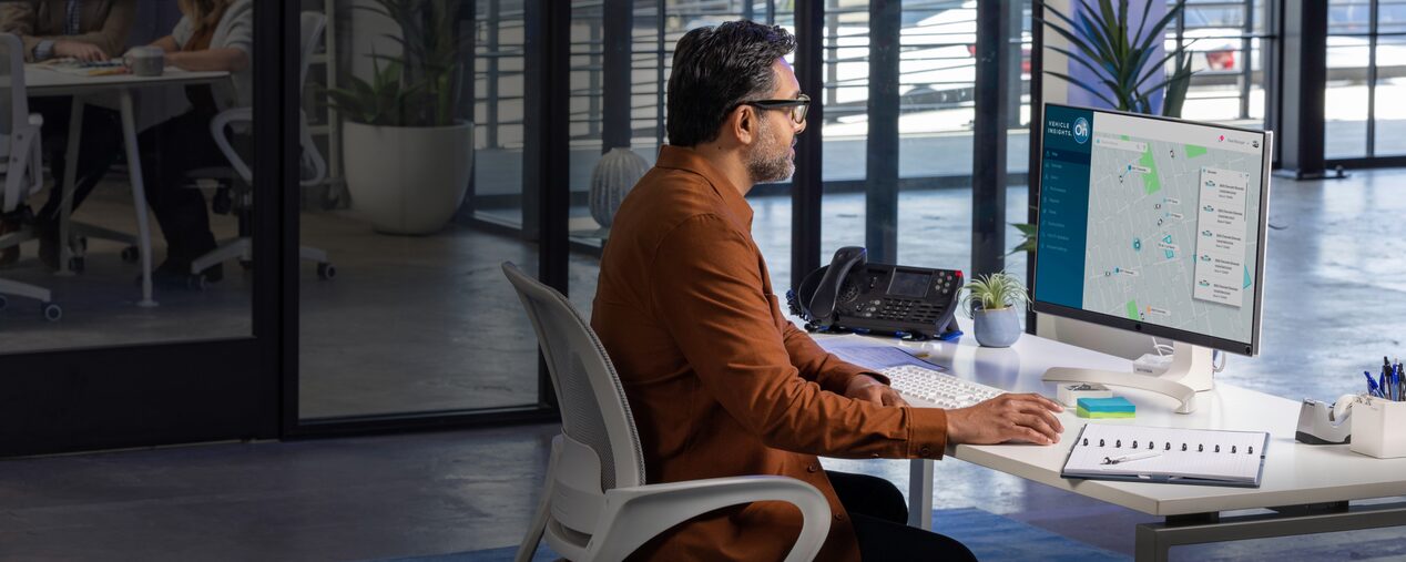 A side profile shot of a man working at a desk