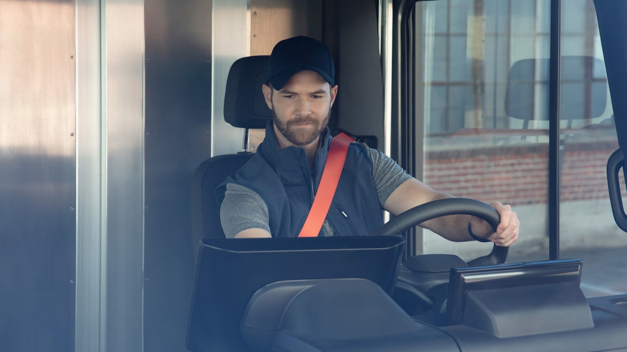 Front shot of driver looking at infotainment screen of vehicle