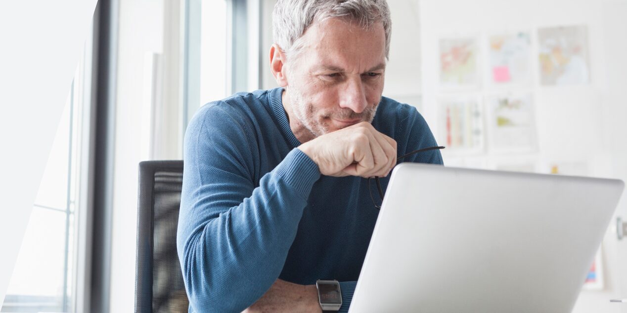 Man looking down at computer