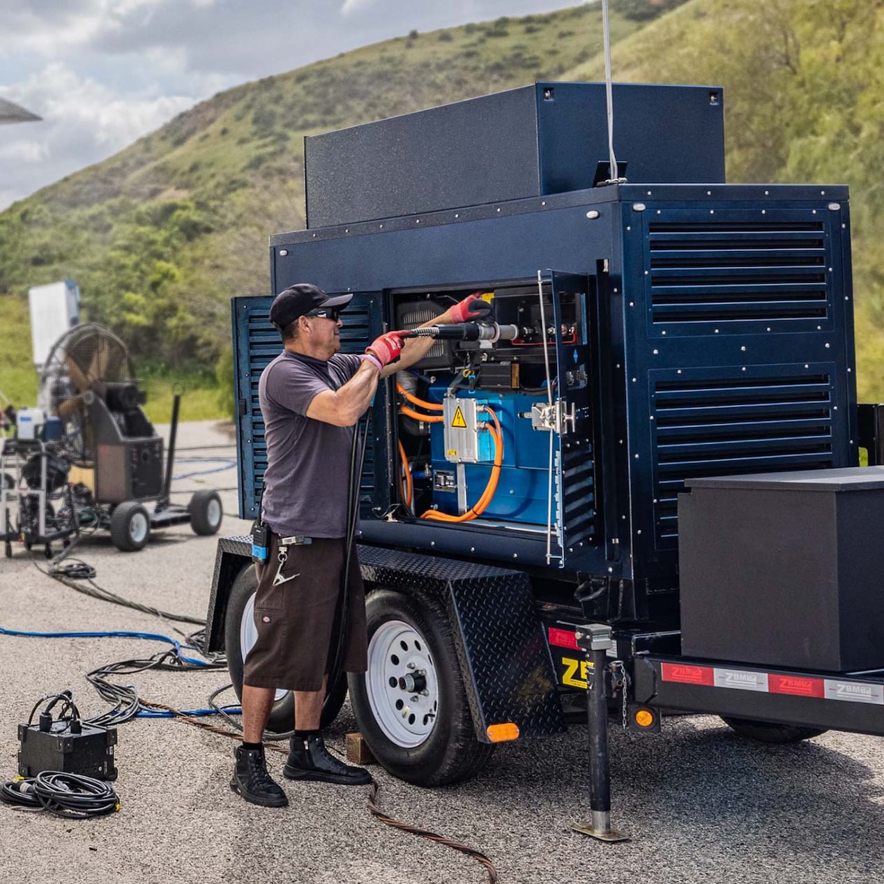 Someone servicing a GM hydrogen-powered mobile generator