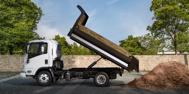  Side View of Chevrolet Low Cab Forward Truck Dumping Dirt Into a Pile