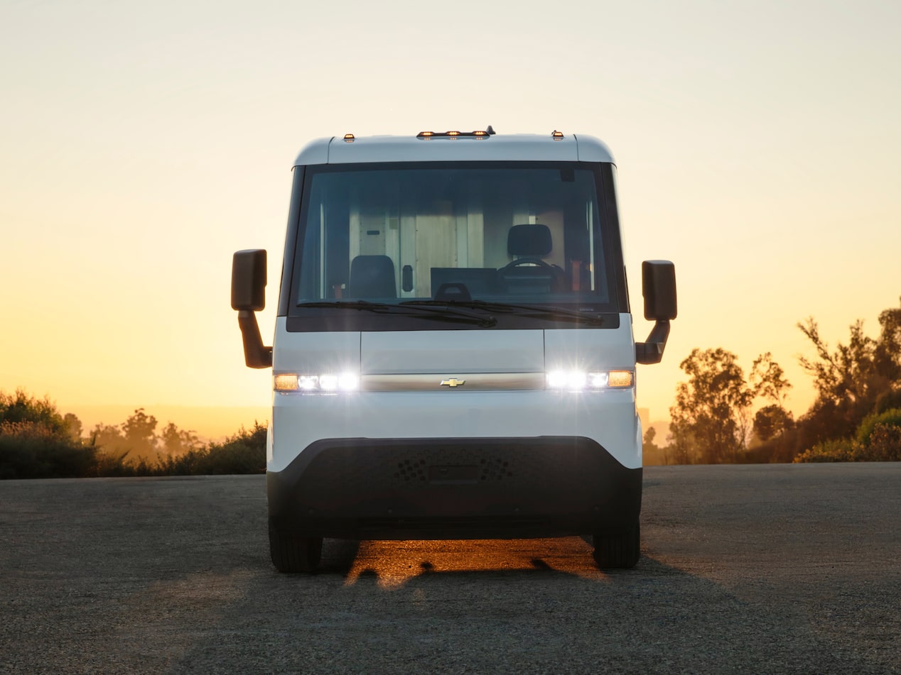 A front-facing exterior  shot of the 2024 Chevrolet Brightdrop with its headlights on