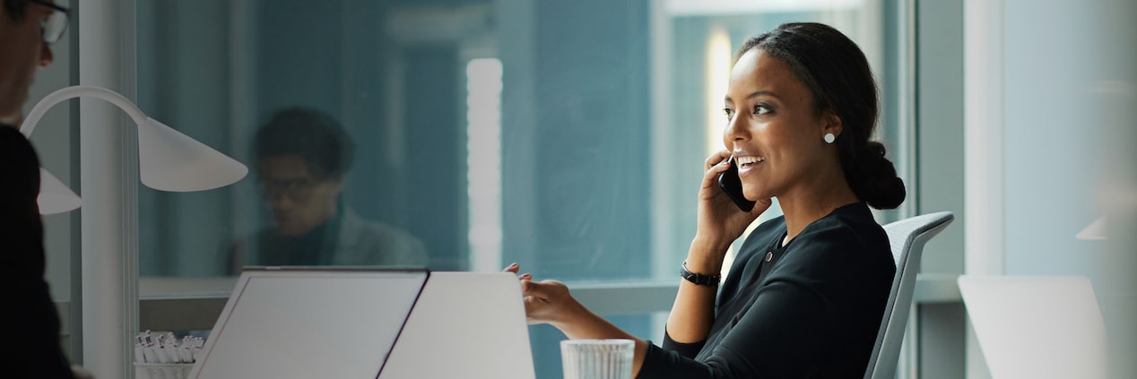 A woman speaking on the phone in her office