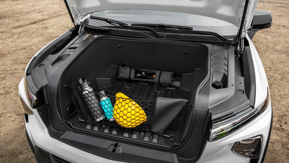 A closeup shot looking down at the trunk of the Summit White 2024 Chevrolet  EV.