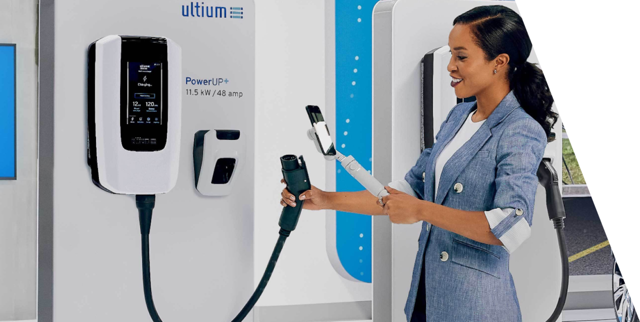 A Woman Using an Electric Vehicle Charging Station