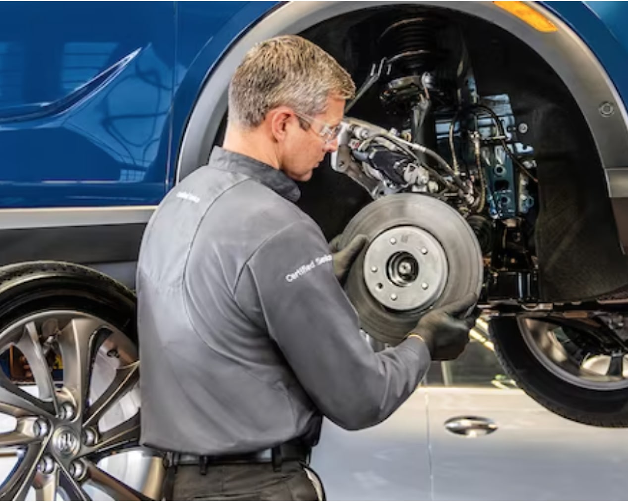 GM Technician Installing a Brake Rotor on a Vehicle