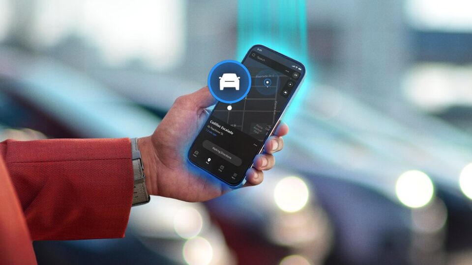 A person using a smartphone to access the Vehicle Locate feature of the OnStar mobile app.