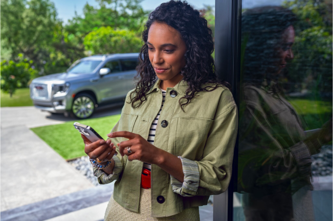 A woman using her smartphone to use OnStar remote commands