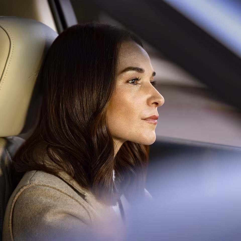 A Close up View of a Woman driving with Alexa.