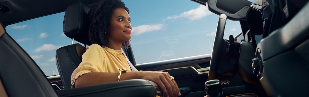 Woman driving confidently with OnStar.