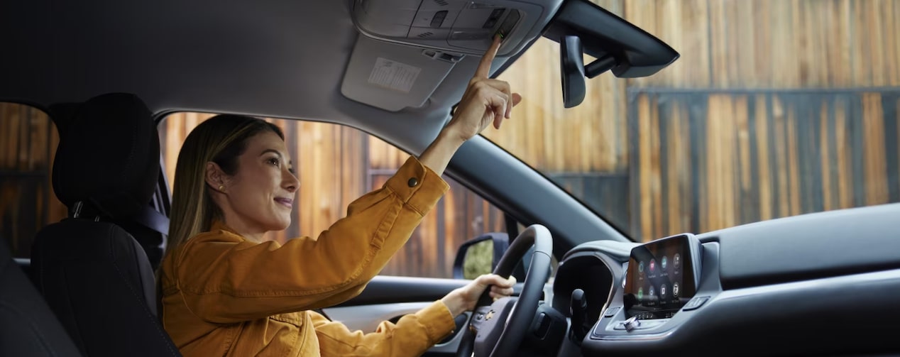 Woman presses OnStar button.