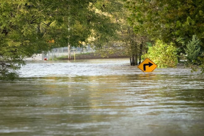 A flooded area with a traffic sign barely visible anymore.