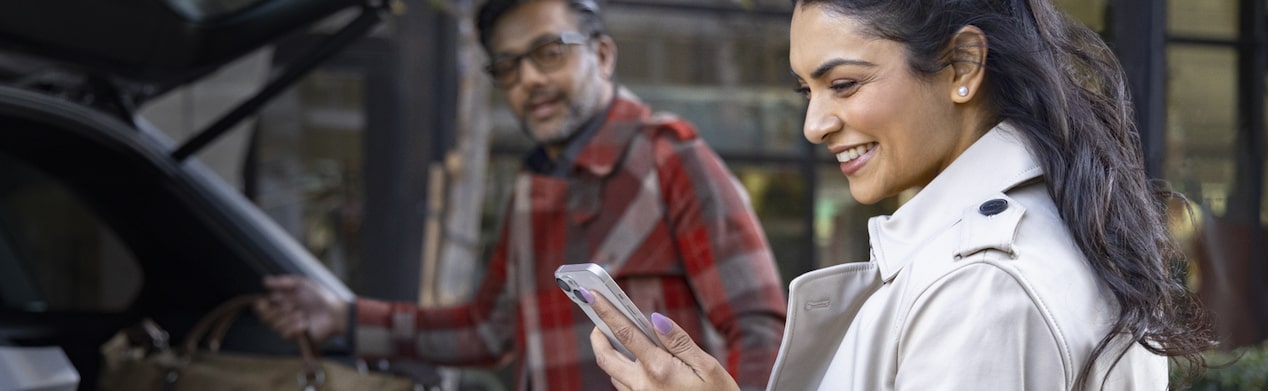 Couple using OnStar Guardian App before a trip.