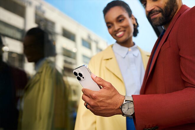 A couple using a smartphone to use OnStar remote commands.